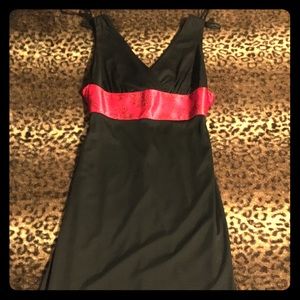 Black dress with red sash that ties in the back